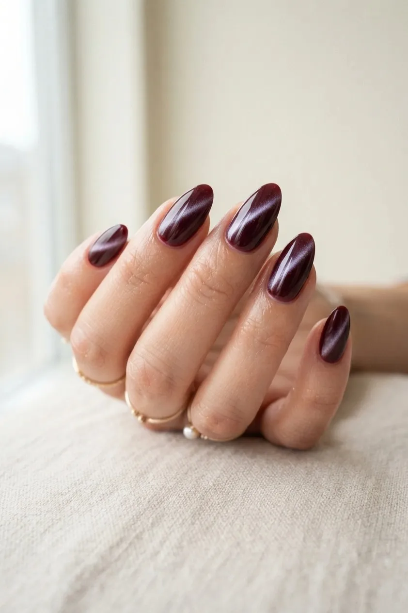 Almond nails in wine magnetic cat eye gel with a band of shimmer down each nail