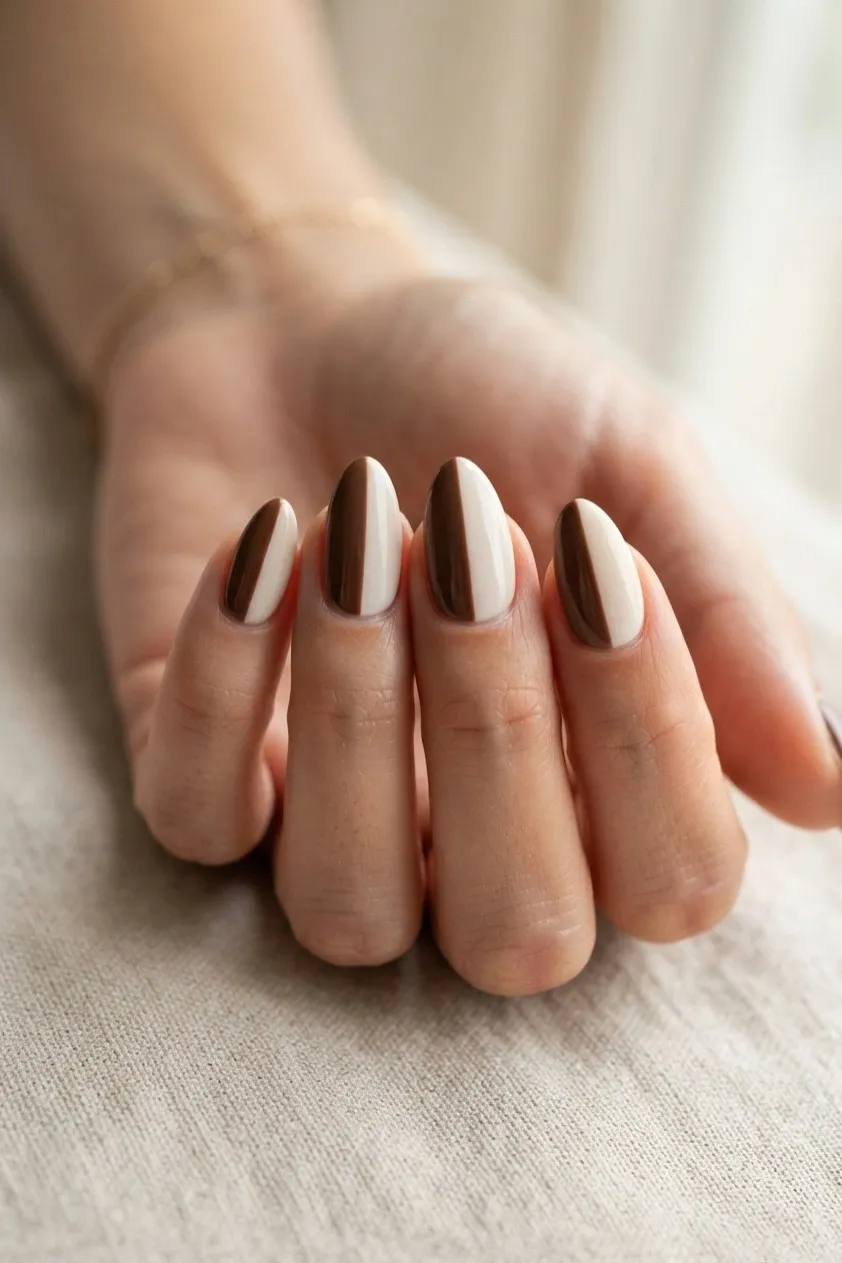 Almond nails split vertically into chocolate brown and cream halves