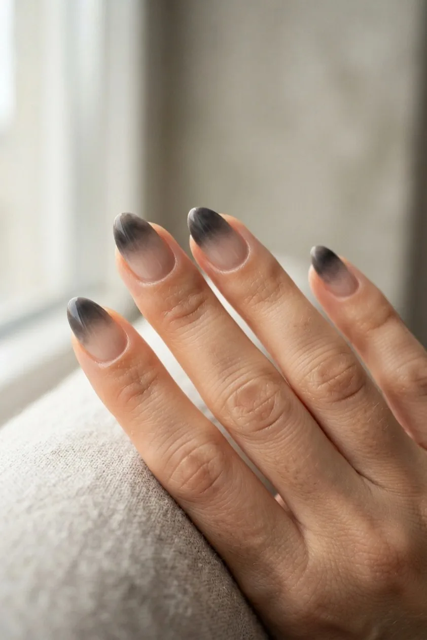 Nude nails with a soft smoky gray gradient blurred into the tip