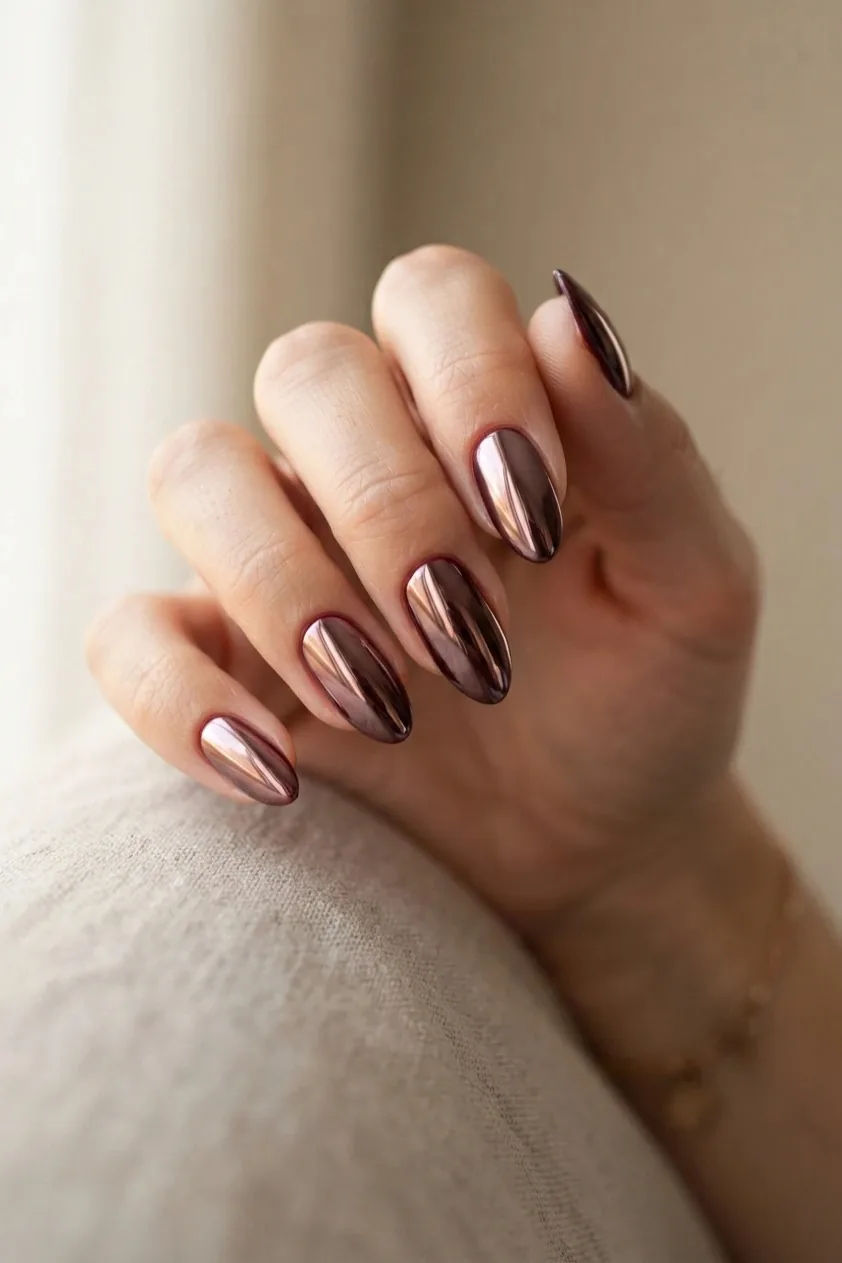 Glossy classic burgundy creme polish on almond nails