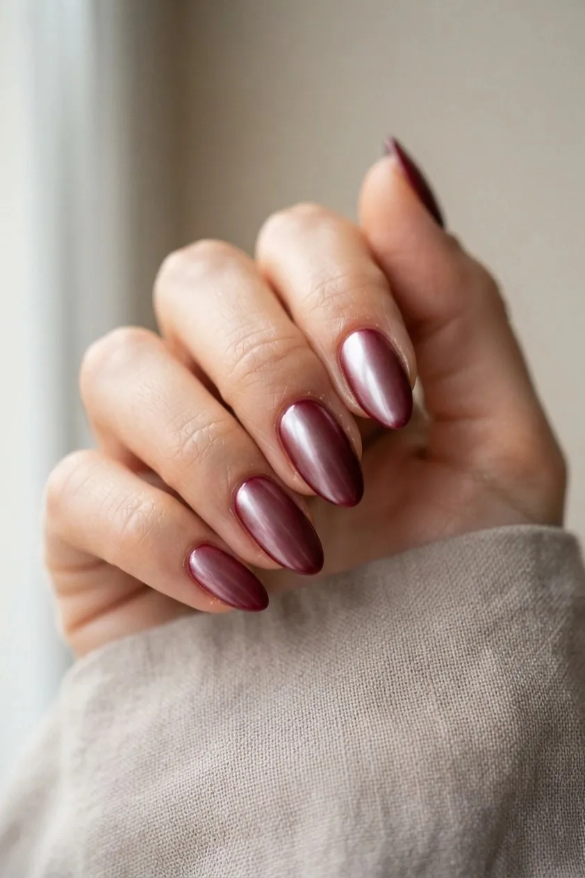 Burgundy nails with a subtle crocodile print texture