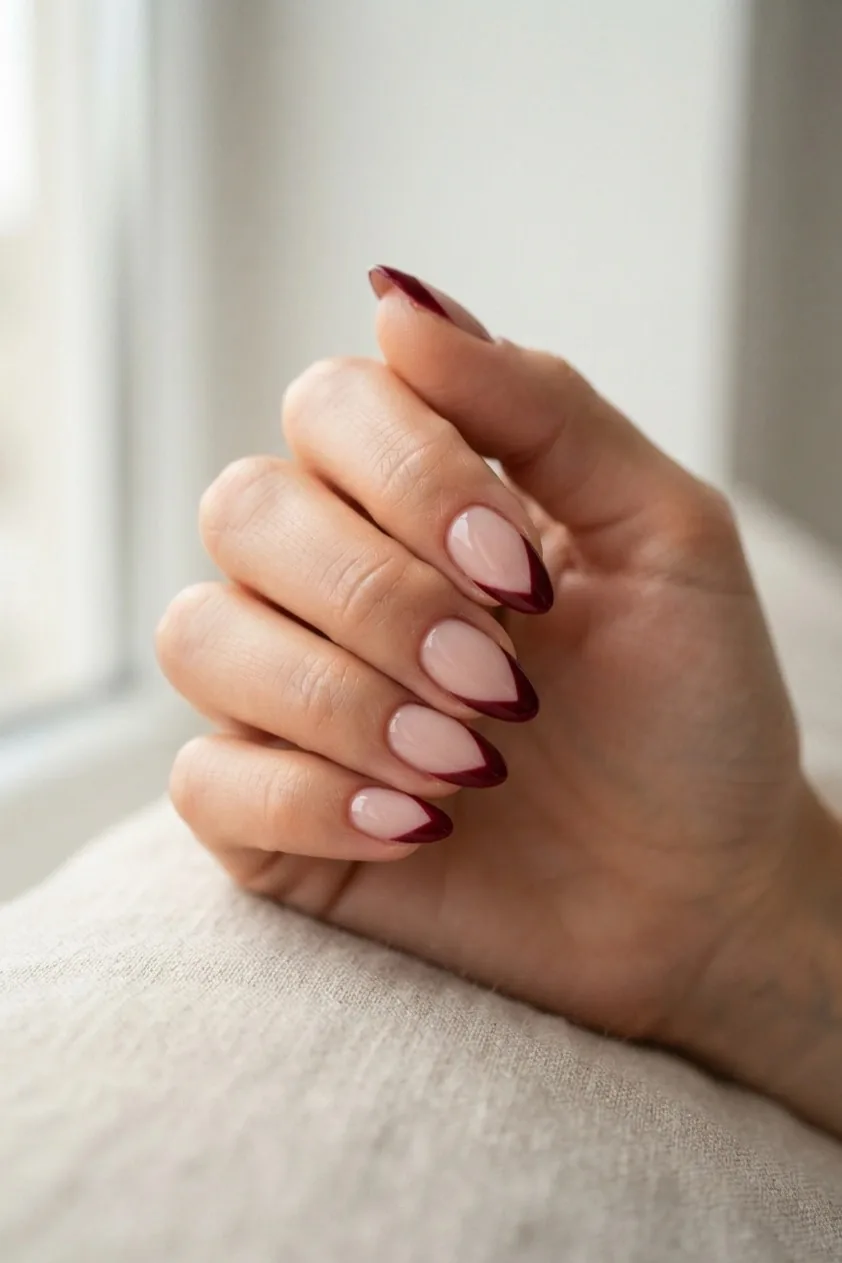 Burgundy French tip cut to a V point at the center of the nail