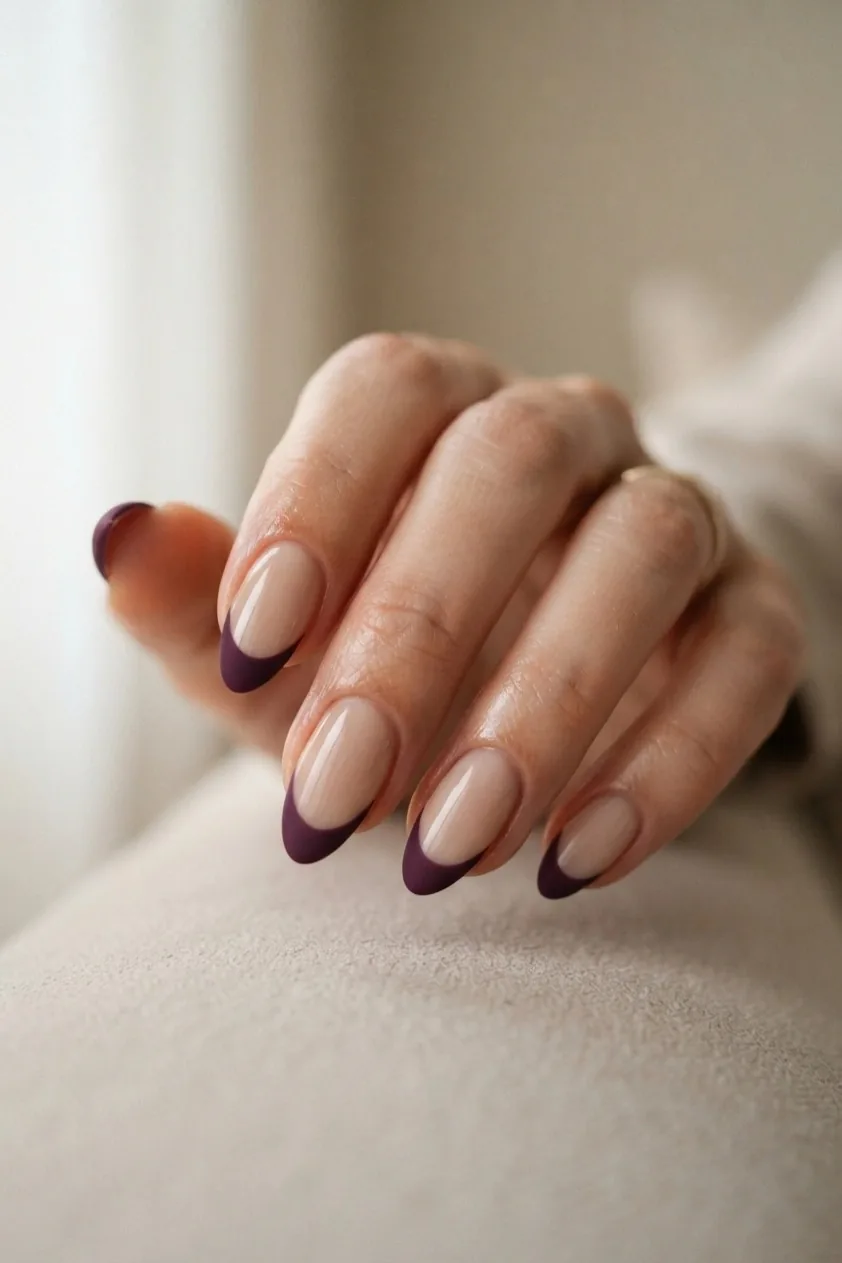 Matte plum French tip set against a glossy nude base