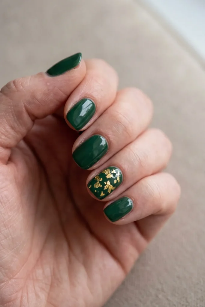 Green Christmas nails with a gold leaf flake accent nail