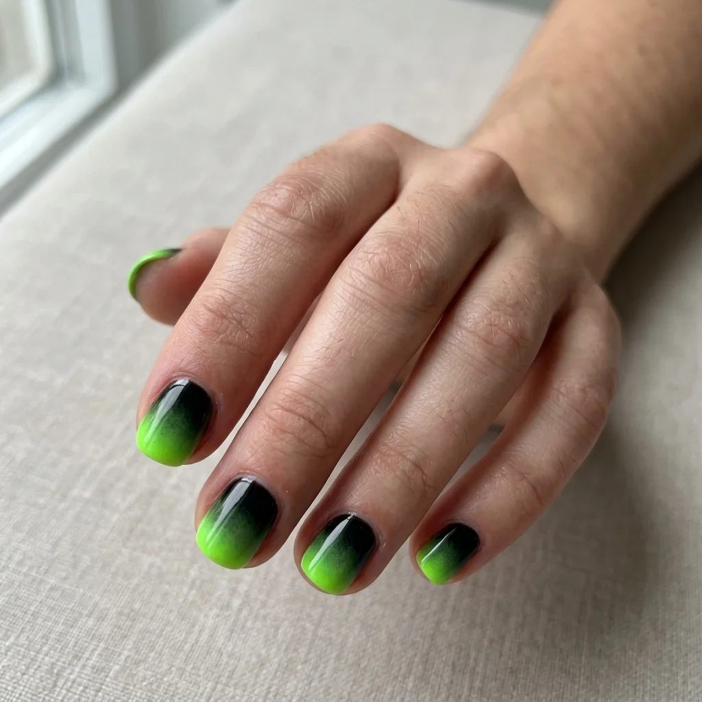 Short moody ombre nails with glowing acid potion green fading into black